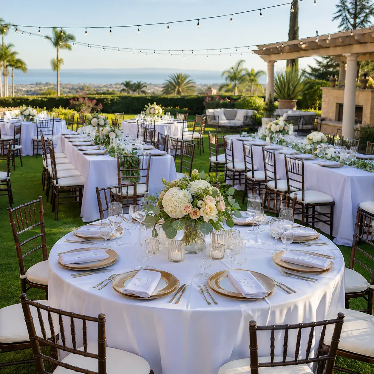 White event tent rental by Ramos Party Rentals with elegant tables, chairs, lighting, and shade for outdoor celebrations.
