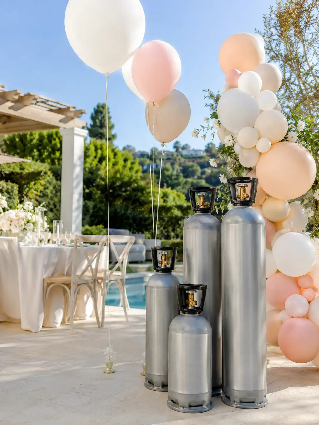 Elegant round event table in Orange County, California, with gold chairs, floral centerpiece, candles, fine tableware, and outdoor sunset setting.